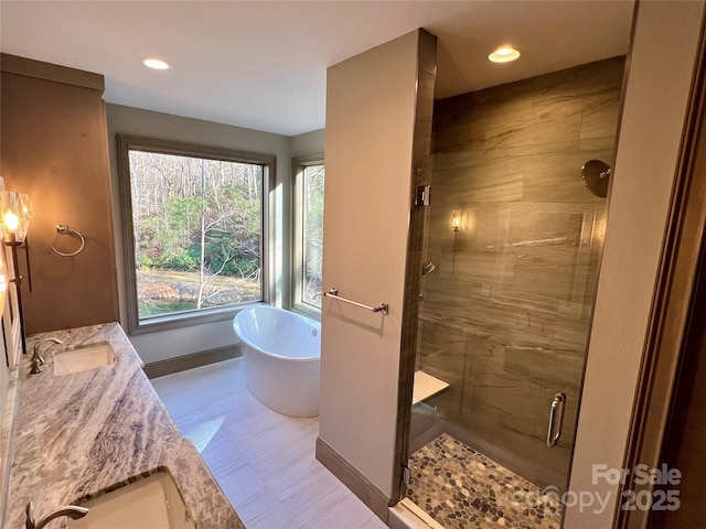 bathroom with vanity and independent shower and bath