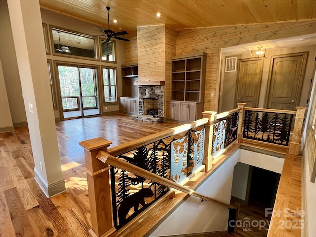 wine cellar with light wood-type flooring, wooden walls, and wood ceiling