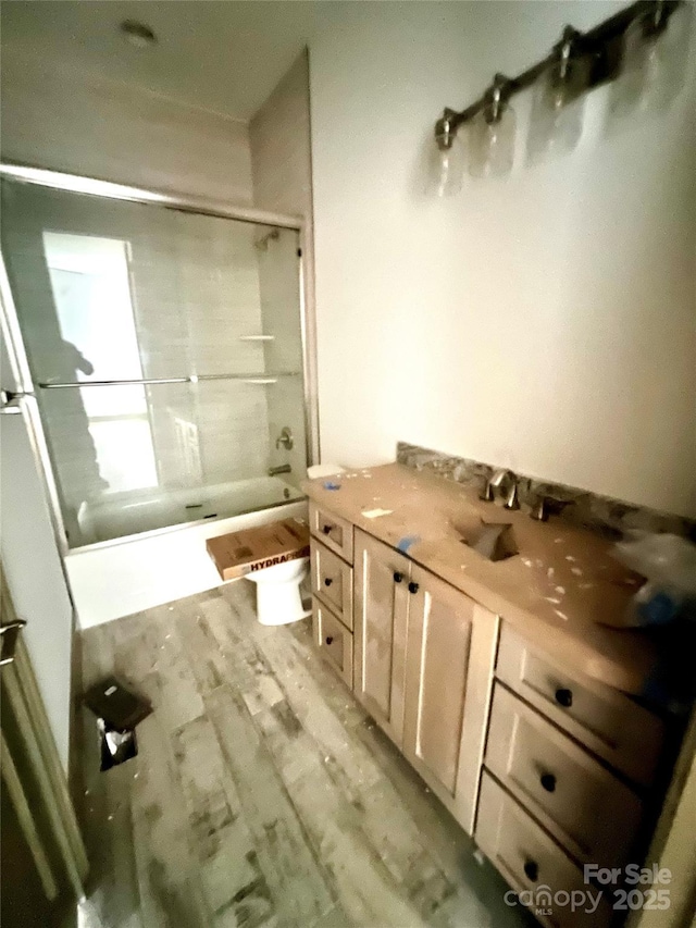 full bathroom with vanity, toilet, bathing tub / shower combination, and hardwood / wood-style floors