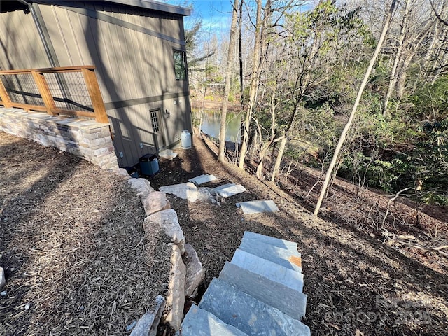 view of yard featuring a water view and cooling unit