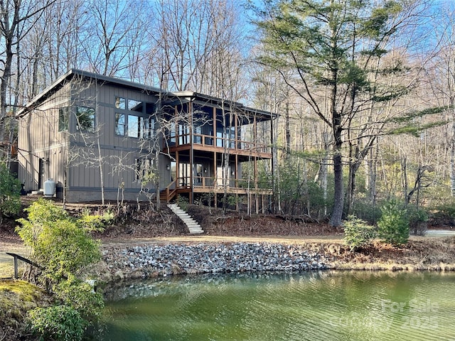 back of house with a deck with water view