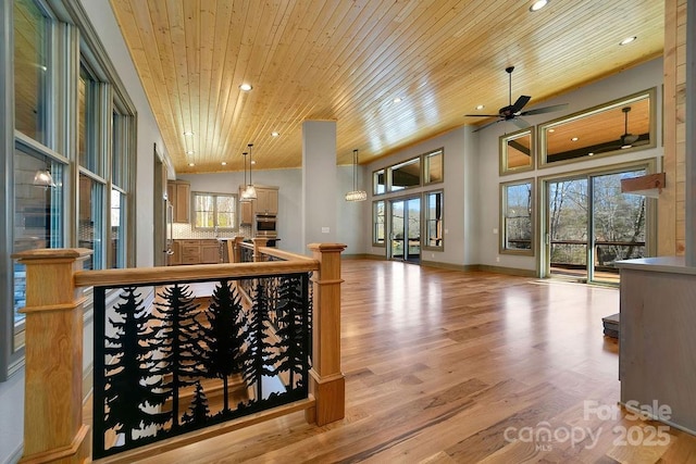 interior space featuring high vaulted ceiling, a wealth of natural light, wooden ceiling, and light wood-style flooring