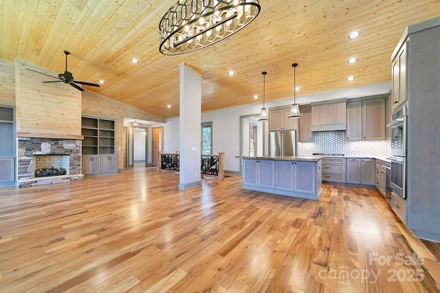 kitchen with wooden ceiling, stainless steel appliances, open floor plan, gray cabinets, and pendant lighting