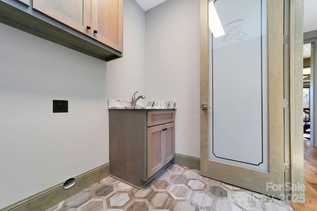 interior space featuring vanity and baseboards