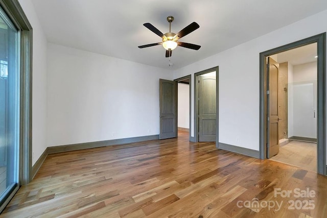 unfurnished bedroom with light wood finished floors, a ceiling fan, and baseboards