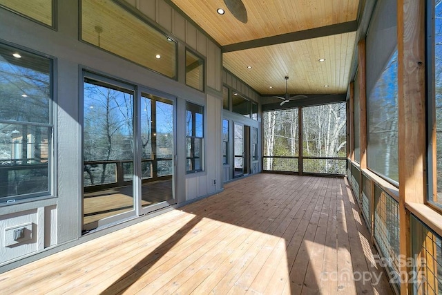 unfurnished sunroom with wood ceiling and a ceiling fan