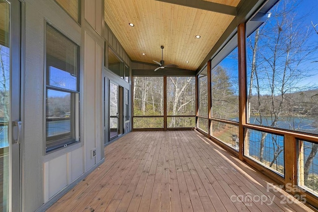 unfurnished sunroom with vaulted ceiling, a water view, wood ceiling, and a ceiling fan