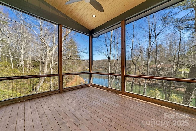 unfurnished sunroom featuring lofted ceiling, wood ceiling, and ceiling fan