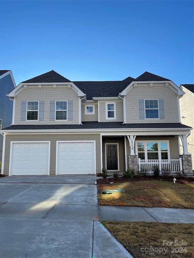 view of front of property featuring a porch and a garage