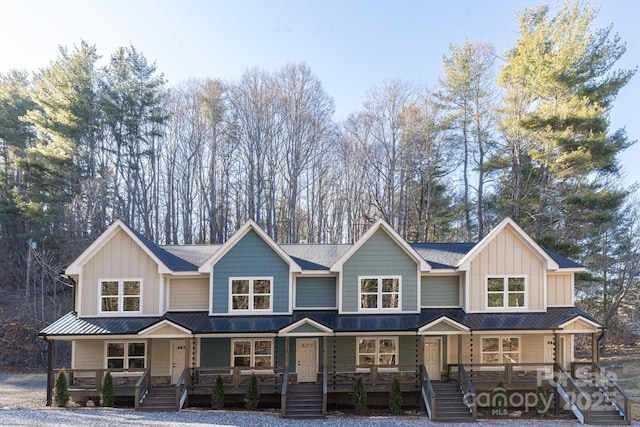 view of front of property with stairs, a porch, and board and batten siding