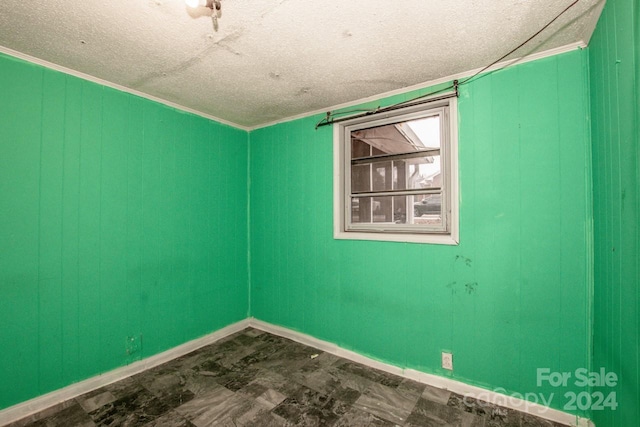 spare room with crown molding