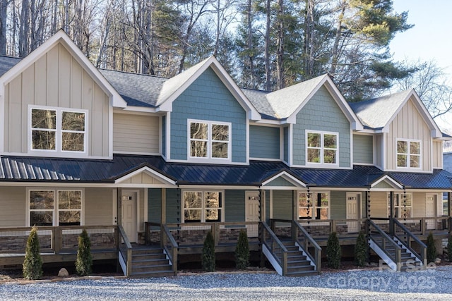 view of front of home featuring a porch, board and batten siding, and stairway