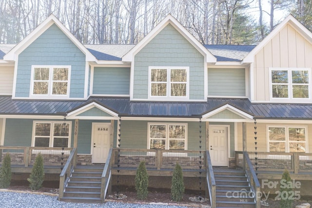 view of property featuring covered porch, metal roof, and board and batten siding