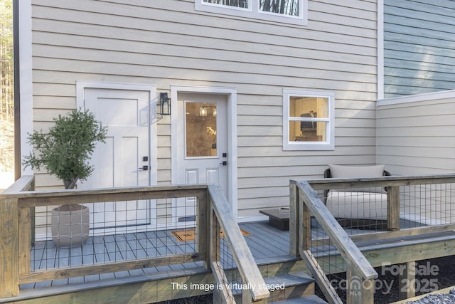 property entrance featuring a wooden deck