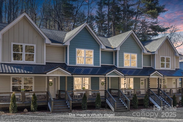 view of front of property featuring covered porch, board and batten siding, and a shingled roof