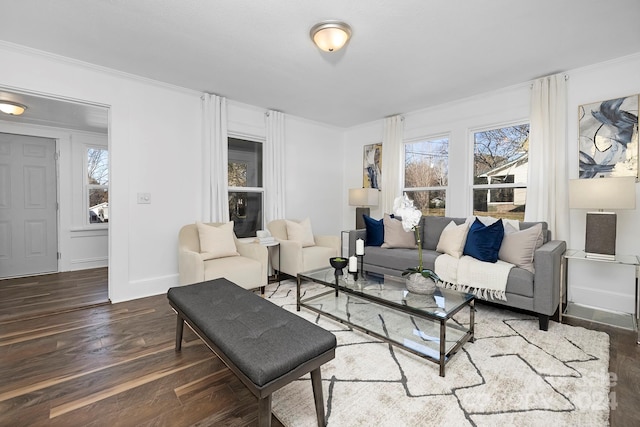 living room featuring dark hardwood / wood-style flooring, crown molding, and a healthy amount of sunlight