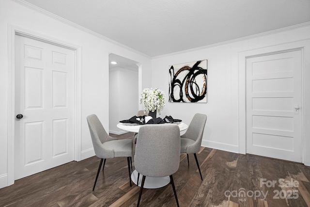 dining area with crown molding and dark hardwood / wood-style floors