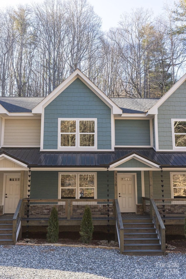 view of front facade featuring metal roof and a porch