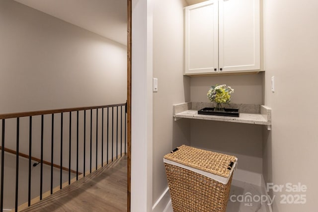 interior space with baseboards and wood finished floors