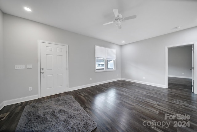 unfurnished room featuring ceiling fan and dark wood-type flooring