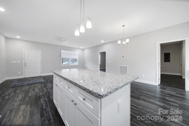 kitchen featuring white cabinets, ceiling fan with notable chandelier, decorative light fixtures, a kitchen island, and dark hardwood / wood-style flooring