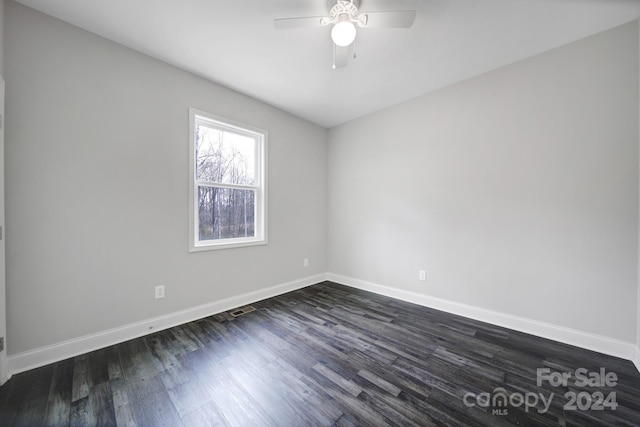 spare room featuring dark hardwood / wood-style flooring and ceiling fan