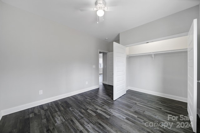 unfurnished bedroom featuring ceiling fan, a closet, dark wood-type flooring, and vaulted ceiling