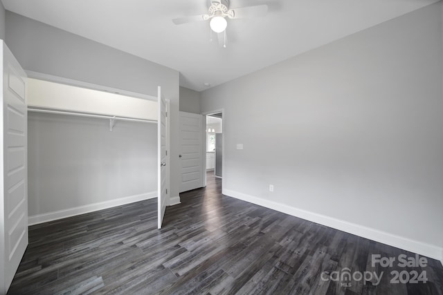 unfurnished bedroom featuring dark hardwood / wood-style flooring, a closet, and ceiling fan