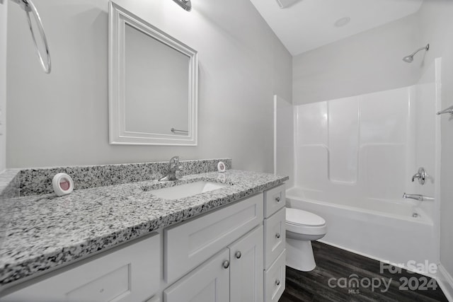 full bathroom featuring vanity, hardwood / wood-style flooring, toilet, and tub / shower combination