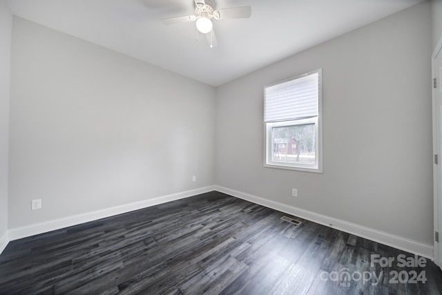 spare room featuring dark hardwood / wood-style floors and ceiling fan