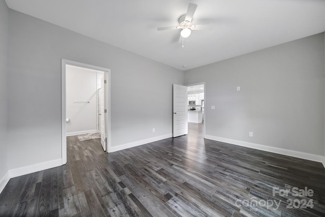 spare room featuring ceiling fan and dark wood-type flooring