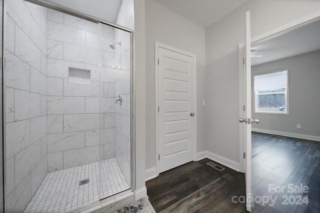 bathroom featuring wood-type flooring and walk in shower