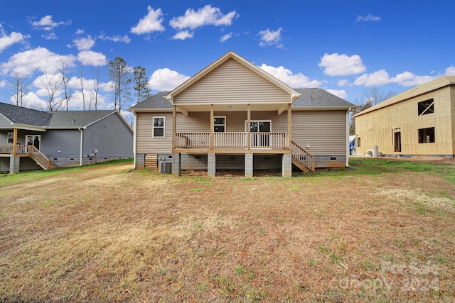 back of house with a lawn and central AC unit