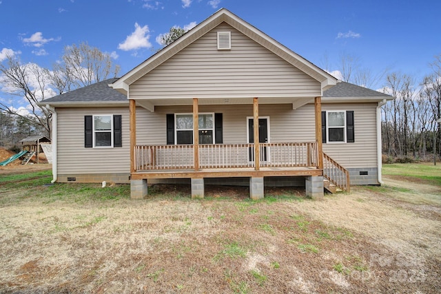 back of house with a lawn