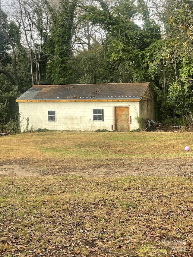 view of outbuilding with a lawn