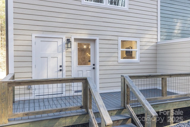 property entrance featuring a wooden deck