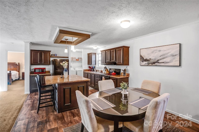 dining room featuring a textured ceiling, washing machine and dryer, and dark hardwood / wood-style floors