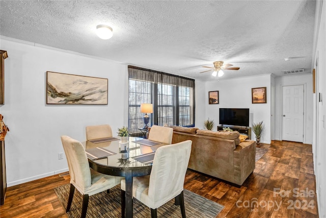 dining space featuring ceiling fan, dark hardwood / wood-style flooring, and a textured ceiling