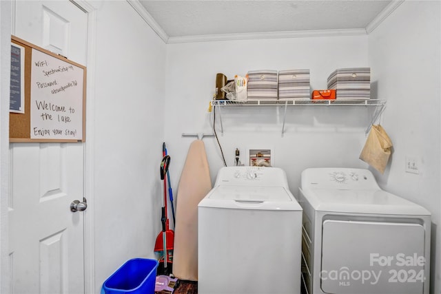 clothes washing area featuring a textured ceiling, independent washer and dryer, and crown molding