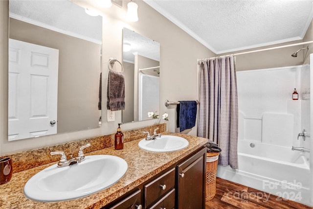 bathroom featuring hardwood / wood-style flooring, shower / bath combo, ornamental molding, and a textured ceiling