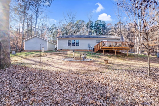 back of property featuring a wooden deck