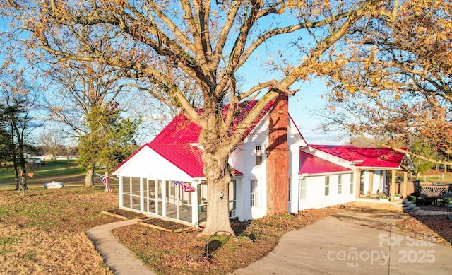 view of side of home featuring a sunroom