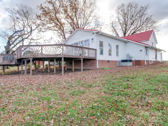 rear view of property featuring a wooden deck