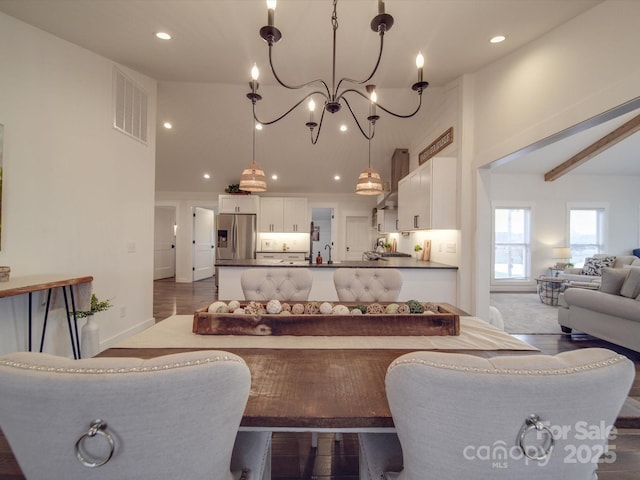 living room featuring a notable chandelier and dark wood-type flooring