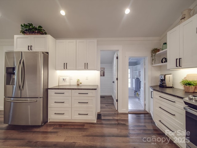 kitchen with appliances with stainless steel finishes, dark hardwood / wood-style flooring, and white cabinetry