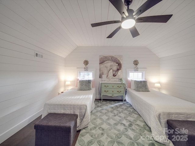 bedroom featuring vaulted ceiling, ceiling fan, wooden walls, and wood ceiling