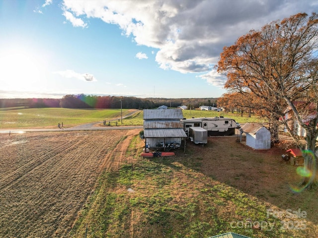 view of yard with a rural view and a shed