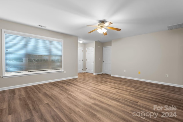 spare room featuring wood-type flooring and ceiling fan