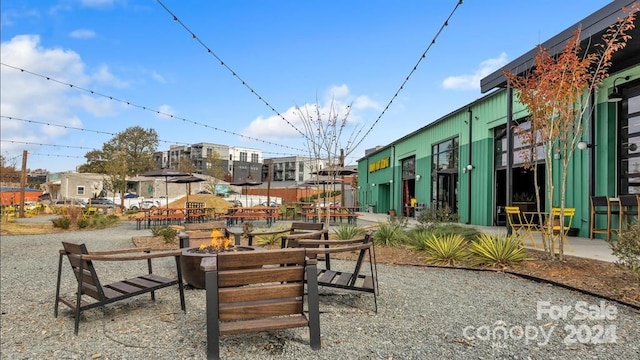 view of home's community featuring an outdoor fire pit