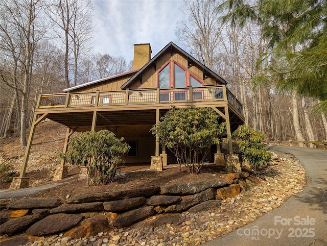 rear view of house featuring a deck